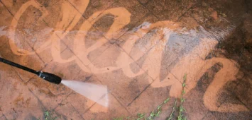 Cleaning backyard with pressure washer. Spring clean up